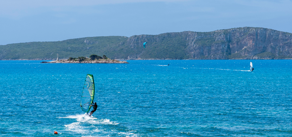 Icon of a man kitesurfing