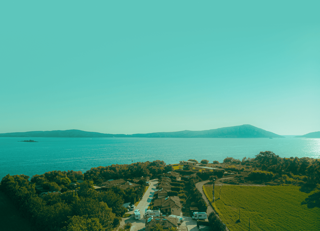 Aerial view of Erodios Camping surrounded by trees next to the sea in Gialova, Messinia